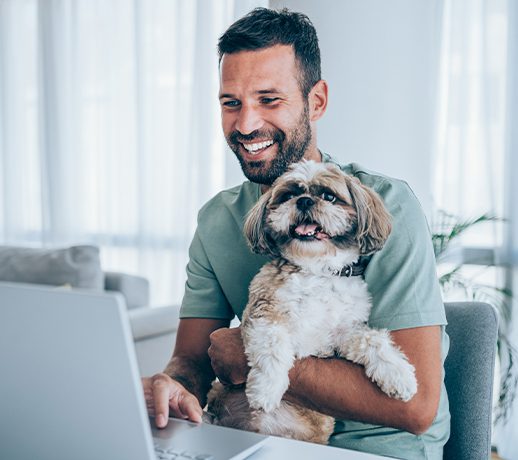 Man At Computer With Dog